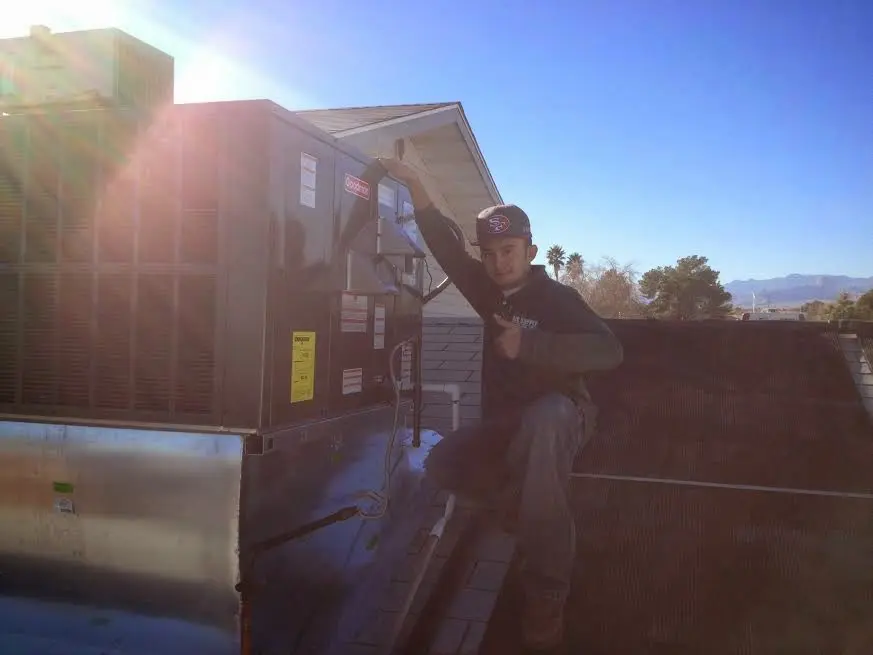 HVAC technician performing Boiler Repair on a rooftop unit in San Carlos